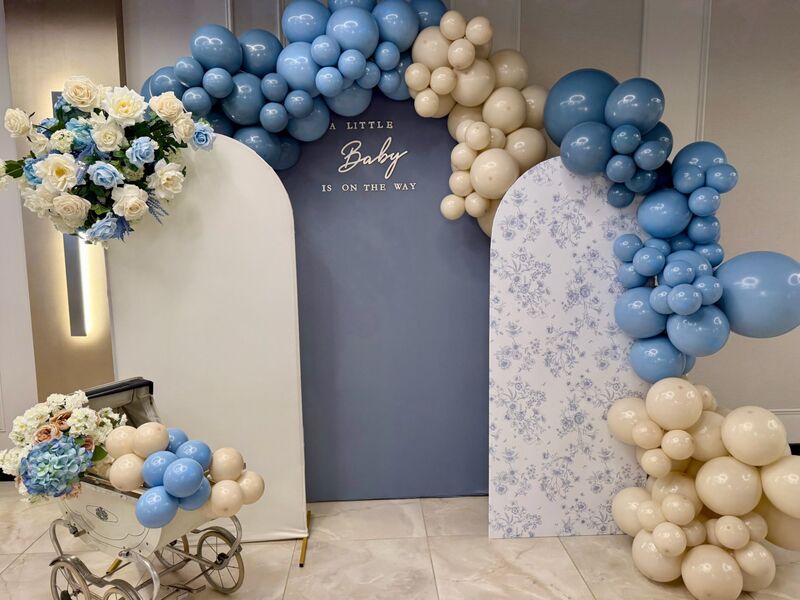 Blue and cream baby shower balloon arch
