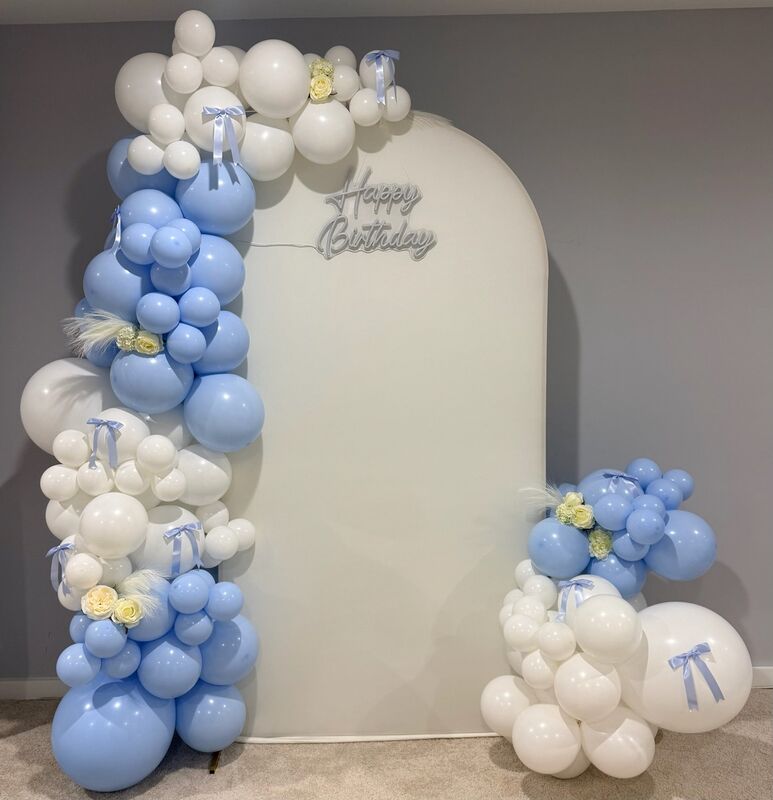 Blue and white birthday balloon arch with bows