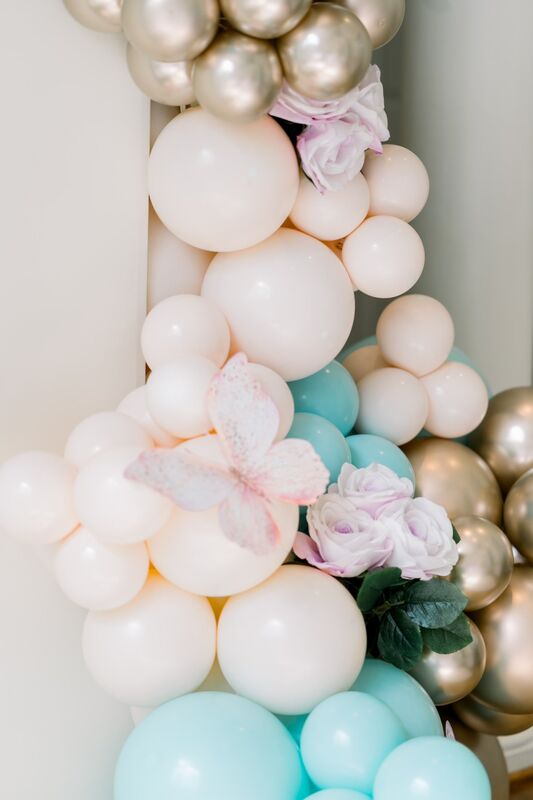 Close-up of blush mint and gold balloon garland with butterfly