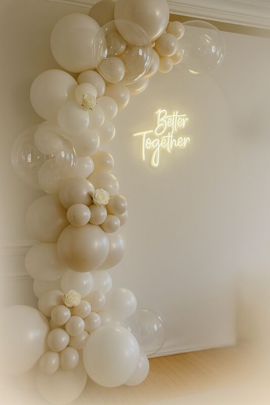 Elegant white balloon arch with Better Together neon sign
